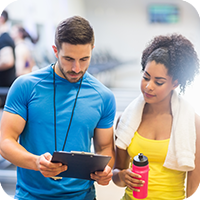 image of woman working with a personal trainer. 